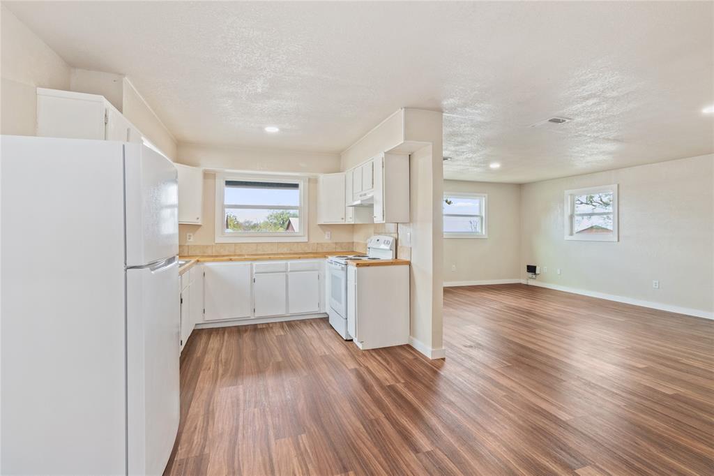 212 East 2nd Street Coleman, TX 76834 - Photo 6 of 17 a kitchen with a refrigerator and window