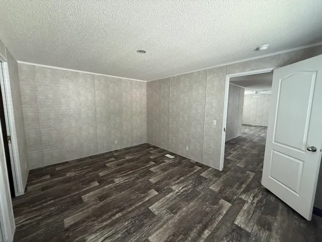 a view of a room with wooden floor and white doors