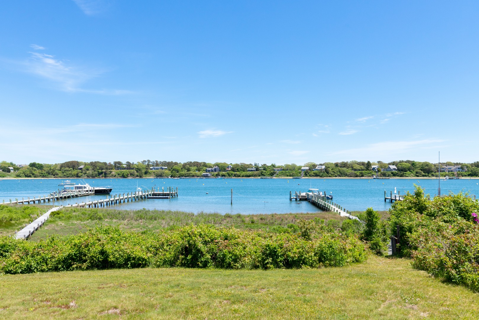 44 Green Hollow Road Edgartown, MA 02539 - Photo 5 of 5 a view of a lake with houses in the back