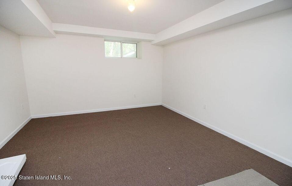 65 Gwenn Loop Staten Island, NY 10314 - Photo 14 of 18 an empty room with a window
