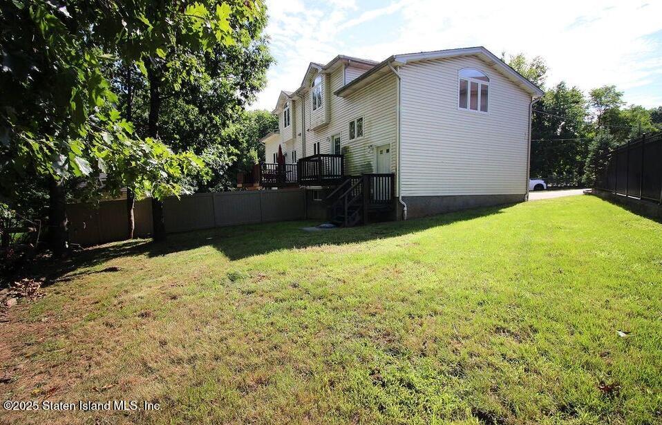 65 Gwenn Loop Staten Island, NY 10314 - Photo 17 of 18 a view of backyard of the house
