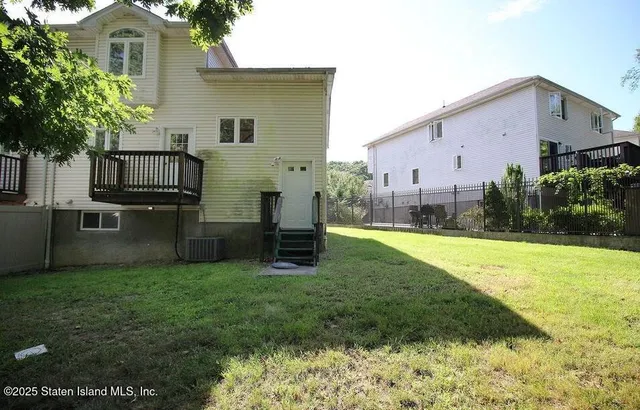 a view of backyard with barbeque grill and plants
