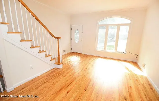 a view of an entryway with wooden floor