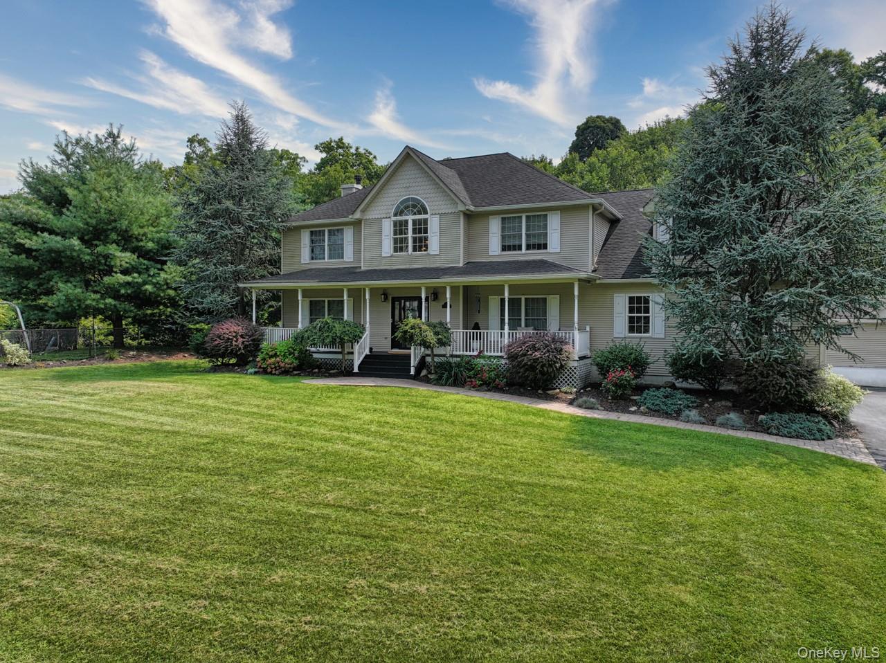 9 Roselawn Road Highland Mills, NY 10930 - Photo 1 of 46 Colonial inspired home featuring covered porch, a large, front lawn, and roof with solar panels (owned)
