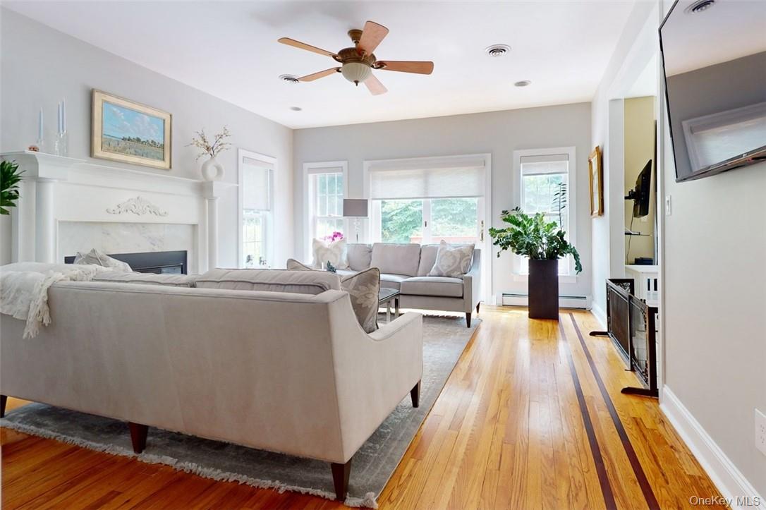 9 Roselawn Road Highland Mills, NY 10930 - Photo 11 of 46 Living room featuring ceiling fan, baseboard heating, and light hardwood / wood-style floors