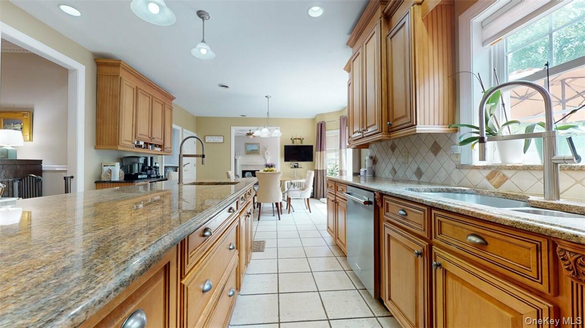 9 Roselawn Road Highland Mills, NY 10930 - Photo 15 of 46 Kitchen with decorative light fixtures, decorative backsplash, stainless steel dishwasher, sink, and light tile patterned flooring