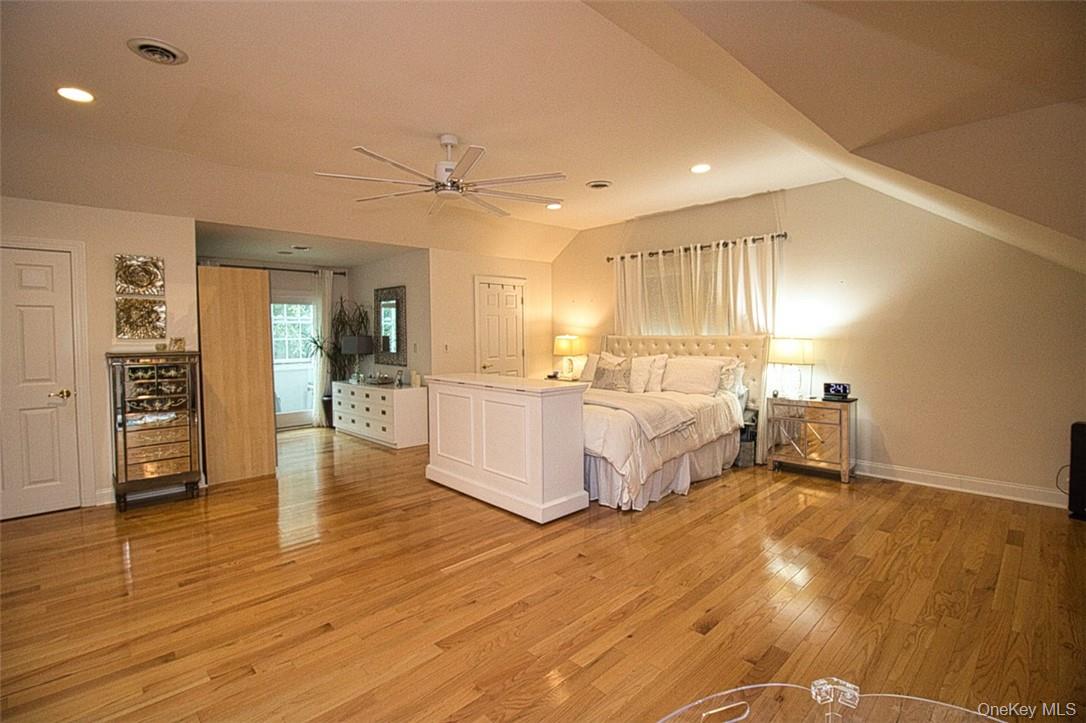 9 Roselawn Road Highland Mills, NY 10930 - Photo 20 of 46 En-Suite primary bedroom with vaulted ceiling, beautiful new ceiling fan, alcove,sitting room, dressing area, and wood flooring