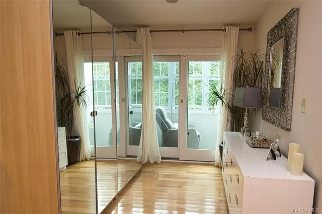 a view of a patio with table and chairs potted plants with wooden floor and fence