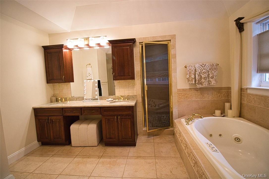 9 Roselawn Road Highland Mills, NY 10930 - Photo 26 of 46 En-Suite Bathroom featuring Jacuzzi, marble tile flooring, tumbled marble shower,new sinks, new granite,new sink faucets, gorgeous new light fixture and vanity