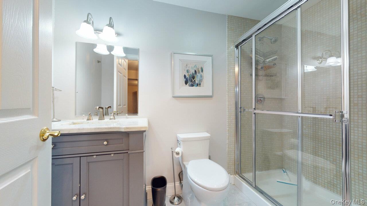 9 Roselawn Road Highland Mills, NY 10930 - Photo 30 of 46 Bathroom in basement with vanity and a shower stall, newer vanity, gorgeous floor tiles.