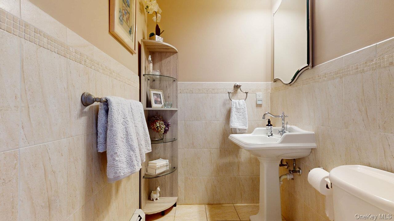 9 Roselawn Road Highland Mills, NY 10930 - Photo 4 of 46 Bathroom featuring tile walls, tile patterned flooring, and wainscoting