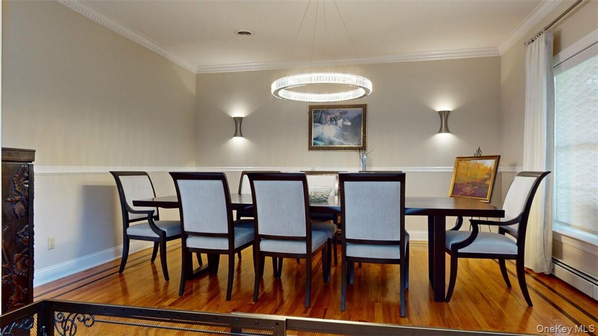 9 Roselawn Road Highland Mills, NY 10930 - Photo 7 of 46 Formal Dining Room featuring wood floors with inlay border, chair rail, dental mouldings, light sconces on wall.
