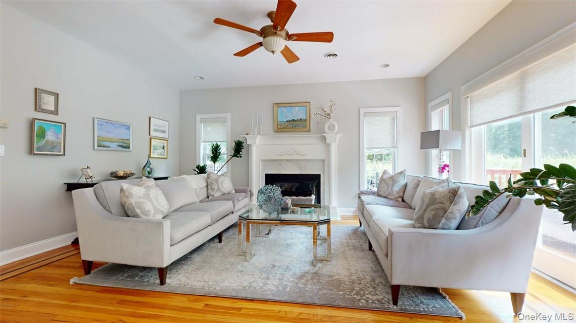 9 Roselawn Road Highland Mills, NY 10930 - Photo 9 of 46 Family Room with light hardwood floors, w/inlay border, a high end fireplace, and ceiling fan