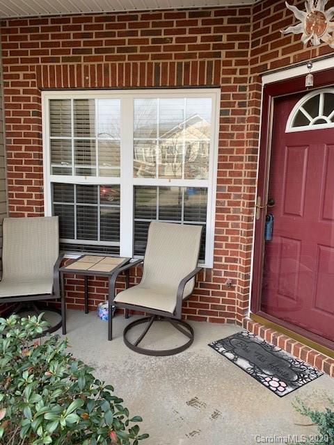 3407 Summerfield Ridge Lane Matthews, NC 28105 - Photo 2 of 11 a balcony with table and chairs and potted plants