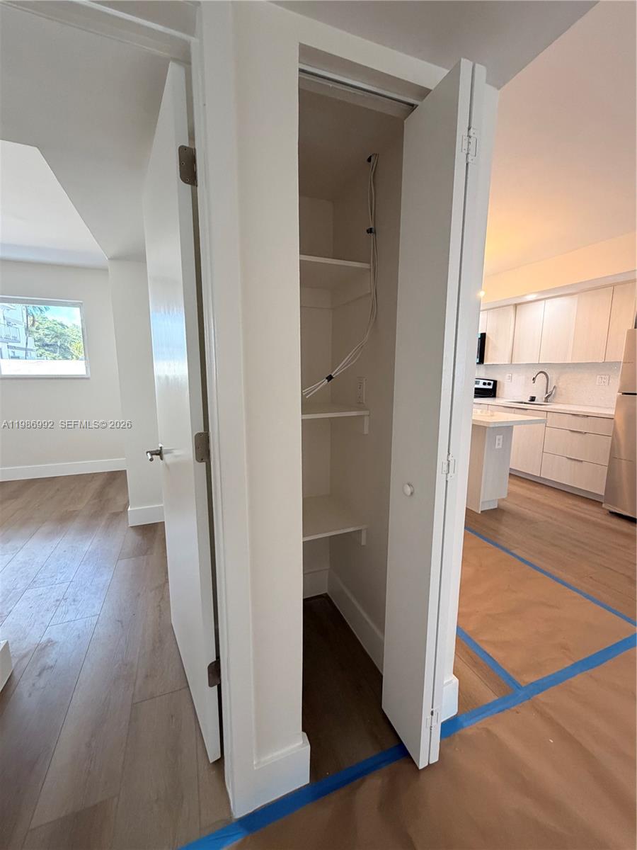 1904 Southwest 17th Avenue, Unit 3 Miami, FL 33145 - Photo 12 of 15 a view of a hallway view with wooden floor and living room