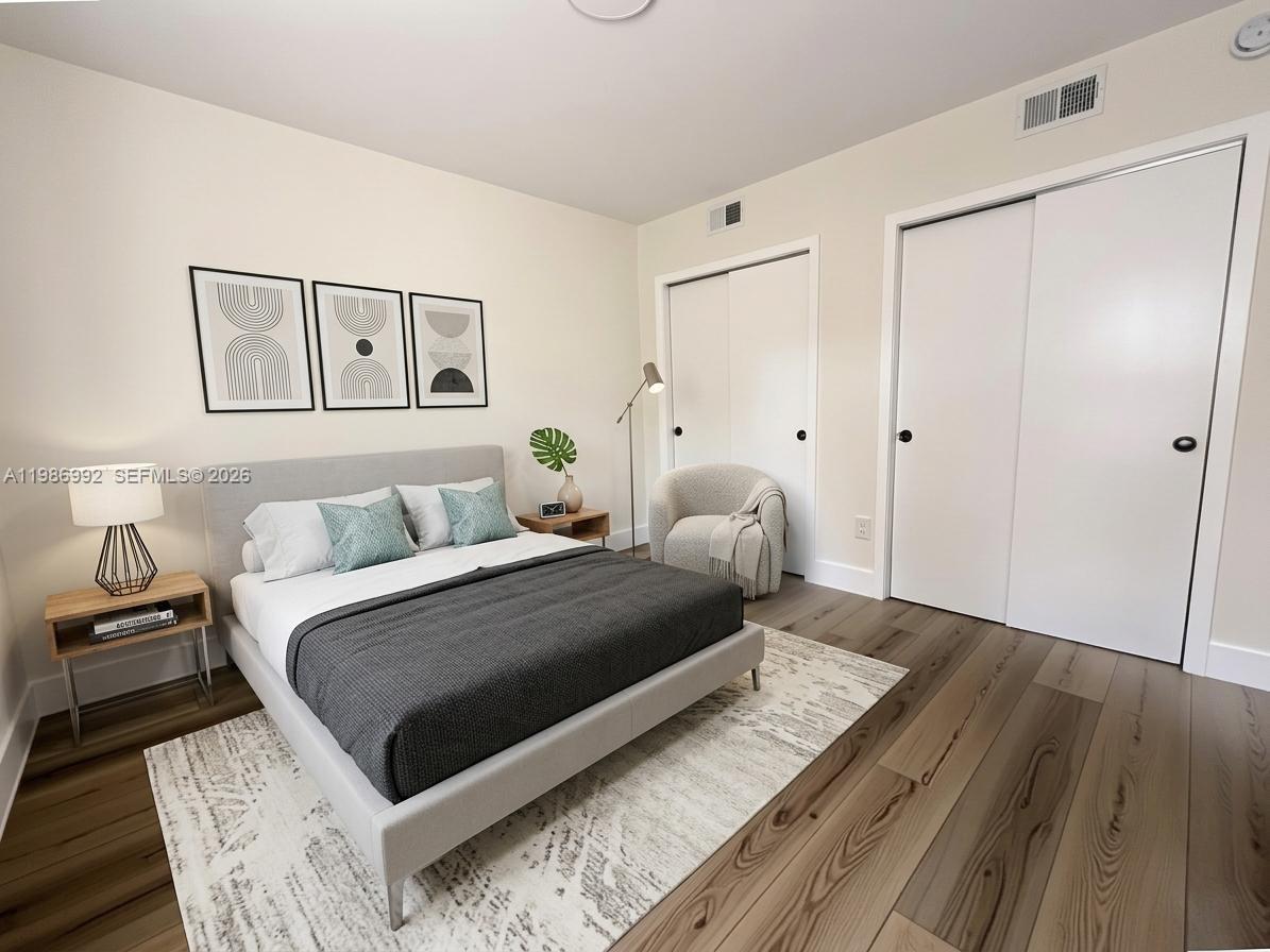 1904 Southwest 17th Avenue, Unit 3 Miami, FL 33145 - Photo 3 of 15 a bedroom with a bed and a painting on the wall