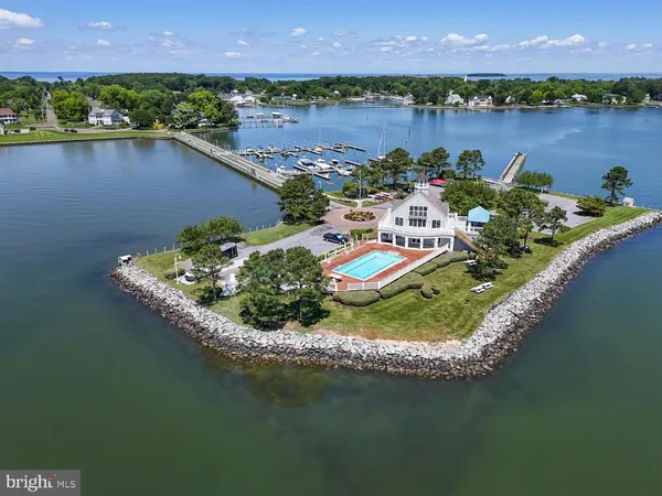 an aerial view of a house with a garden and lake view