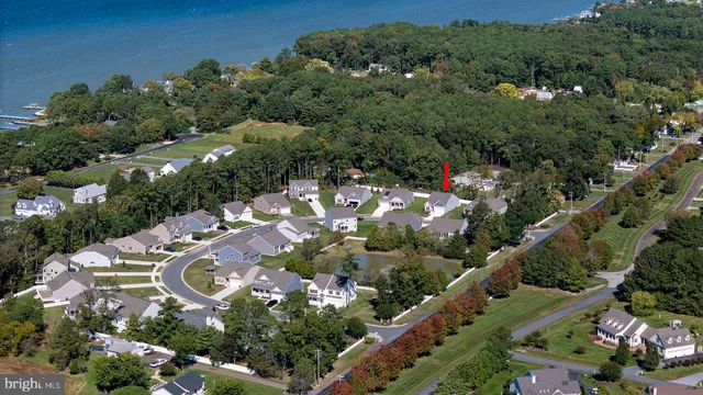 an aerial view of residential houses with outdoor space and street view