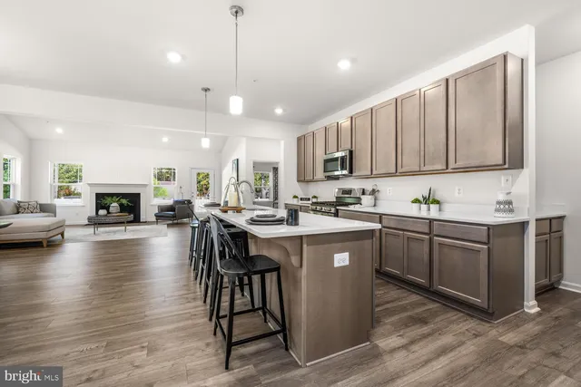 a kitchen with a sink a center island cabinets and a couch