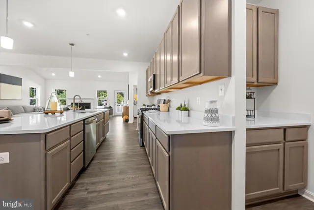 a kitchen with stainless steel appliances granite countertop lots of counter top space and cabinets