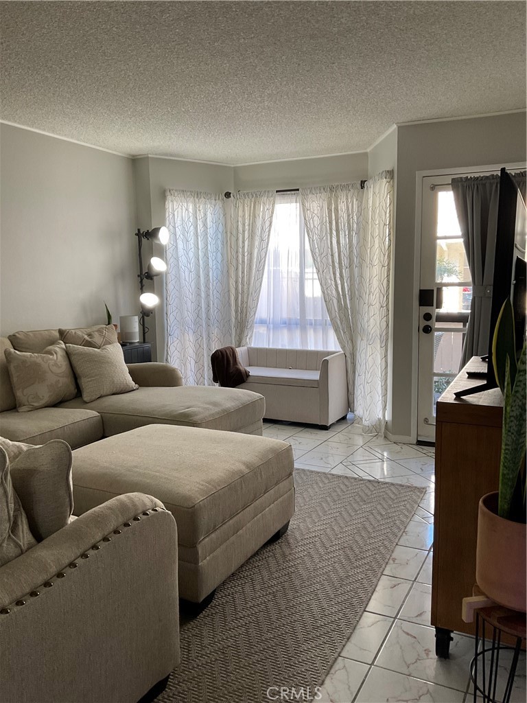 12620 Briarglen Loop, Unit I Stanton, CA 90680 - Photo 11 of 41 a bedroom with furniture and large windows