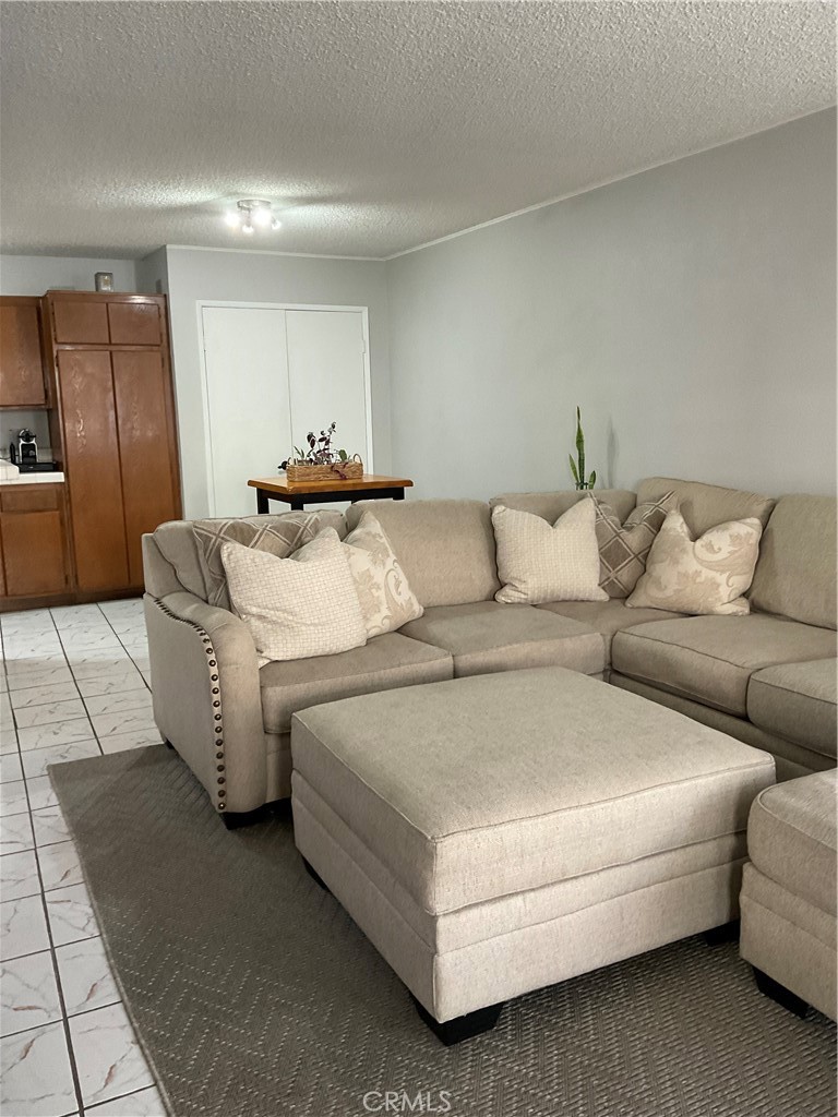 12620 Briarglen Loop, Unit I Stanton, CA 90680 - Photo 12 of 41 a living room with furniture and a couch