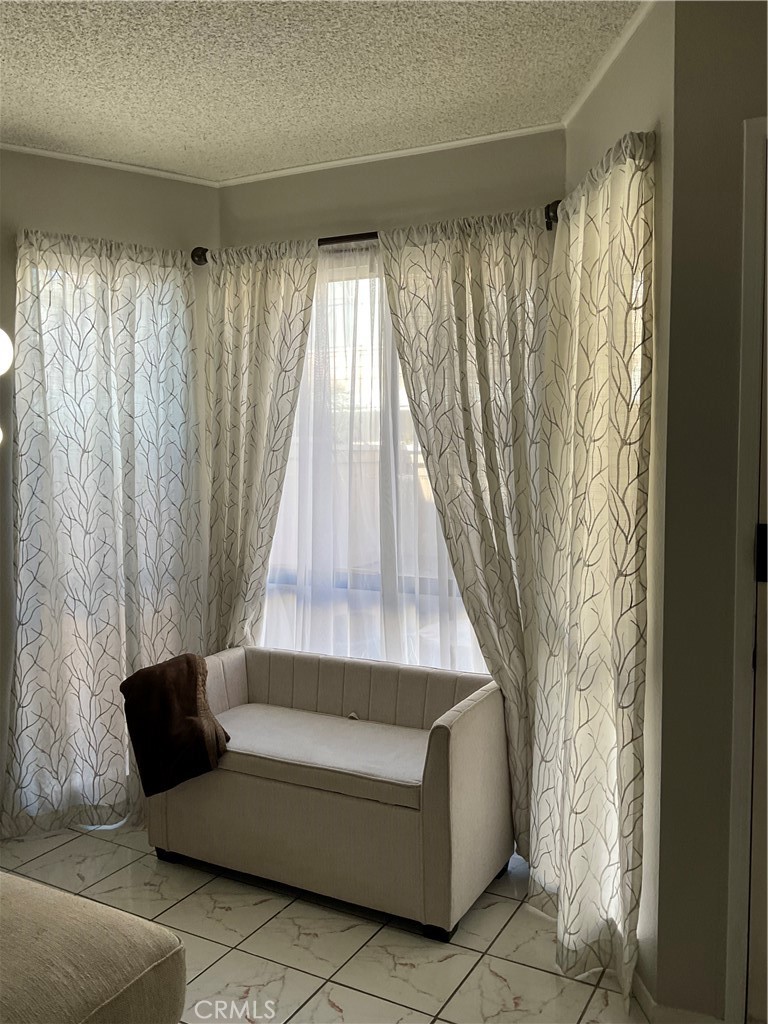 12620 Briarglen Loop, Unit I Stanton, CA 90680 - Photo 14 of 41 a living room with furniture and a window