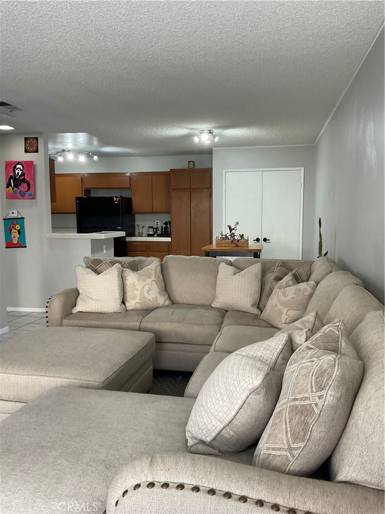 12620 Briarglen Loop, Unit I Stanton, CA 90680 - Photo 15 of 41 a living room with furniture and a flat screen tv