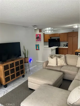 a kitchen with stainless steel appliances kitchen island granite countertop a refrigerator and a stove top oven
