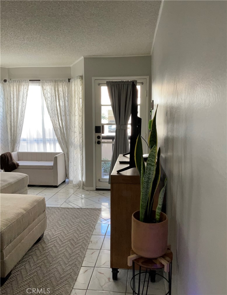 12620 Briarglen Loop, Unit I Stanton, CA 90680 - Photo 19 of 41 a living room with furniture and a window