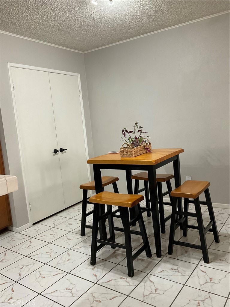 12620 Briarglen Loop, Unit I Stanton, CA 90680 - Photo 24 of 41 a view of a dining room with furniture and wooden floor