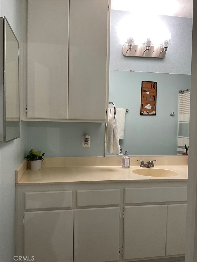 12620 Briarglen Loop, Unit I Stanton, CA 90680 - Photo 30 of 41 a bathroom with a sink and a mirror