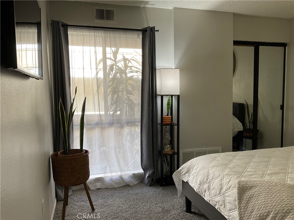 12620 Briarglen Loop, Unit I Stanton, CA 90680 - Photo 33 of 41 a bedroom with a bed and a window
