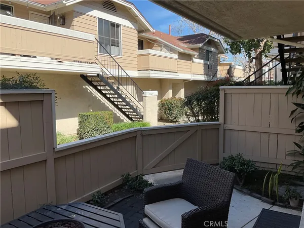a view of a back yard of the house with a chair