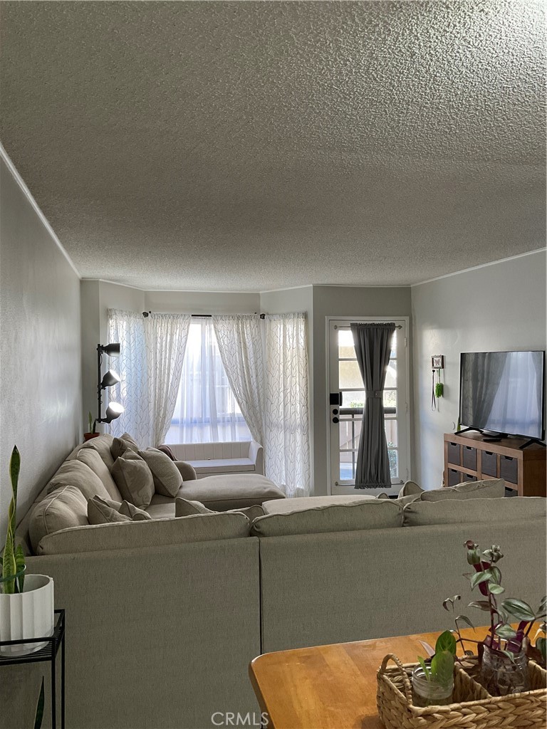 12620 Briarglen Loop, Unit I Stanton, CA 90680 - Photo 8 of 41 a living room with furniture and window