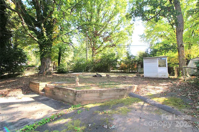 a view of a backyard with large trees