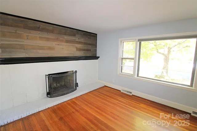 a room with a bed and a fireplace