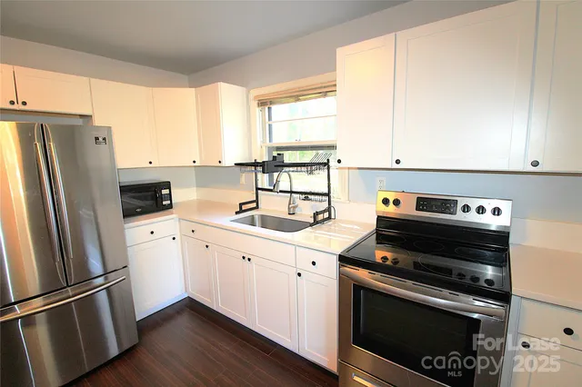 a kitchen with appliances cabinets and a window