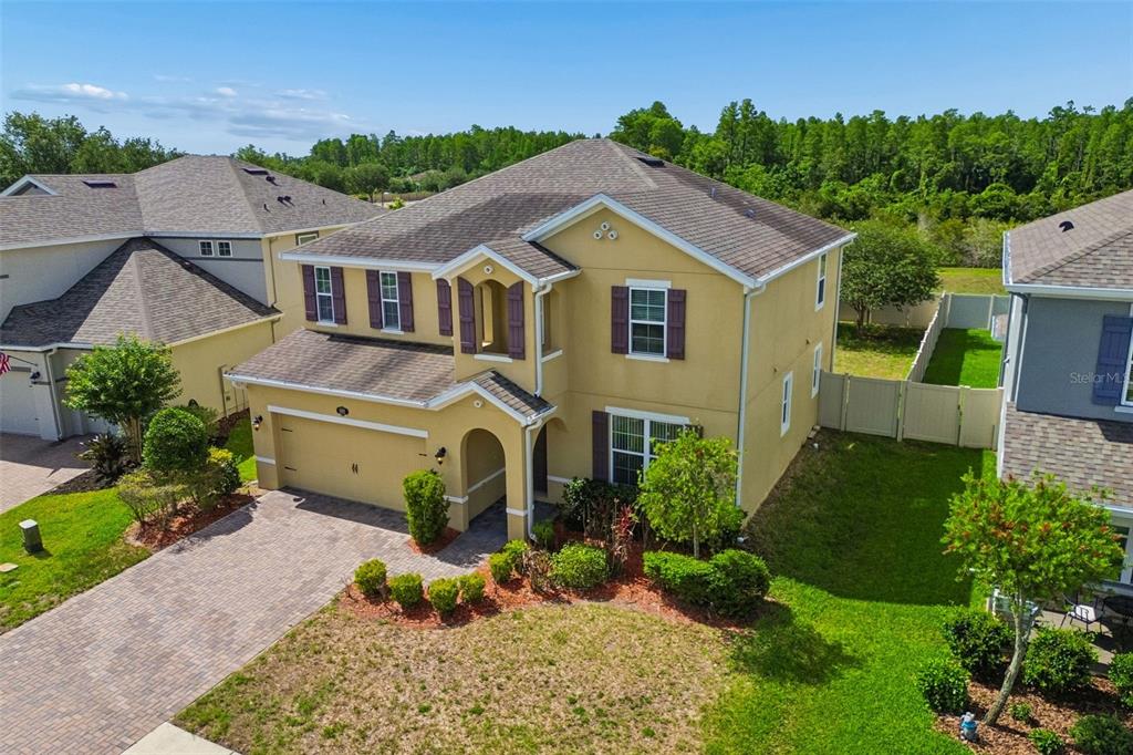 1192 Multiflora Loop Lutz, FL 33558 - Photo 3 of 32 a aerial view of a house with a yard and potted plants