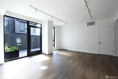 a view of an empty room with potted plants