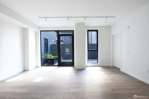 a view of a big room with windows and chandelier