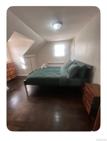 a bedroom with a bed and a night stand