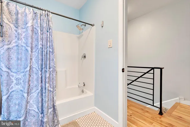 a bathroom with a shower curtain and a bathtub