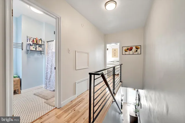 a view of a hallway with wooden floor and entryway