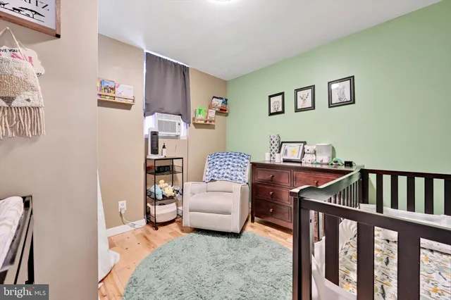 a bedroom with furniture and a wooden floor