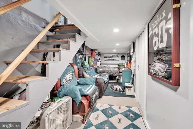 a view of a bedroom with bed and toys
