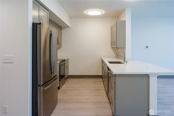 a kitchen with stainless steel appliances a refrigerator and a sink