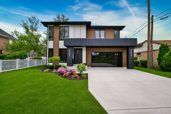 a front view of a house with a garden