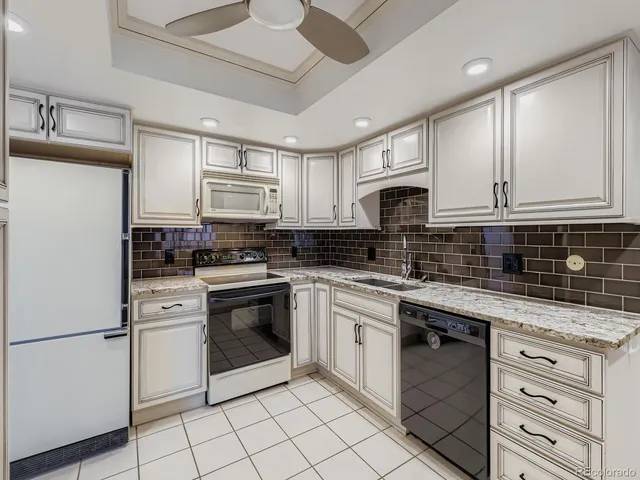 a kitchen with cabinets appliances and a sink