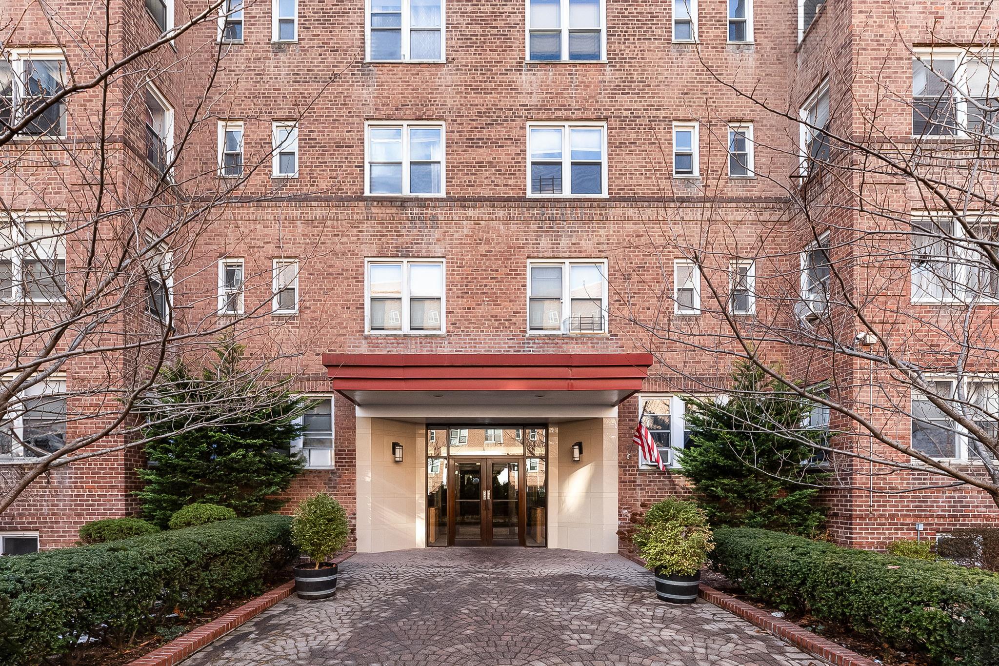 99-31 64th Avenue, Unit E10 Queens, NY 11374 - Photo 13 of 14 a front view of a building with entryway